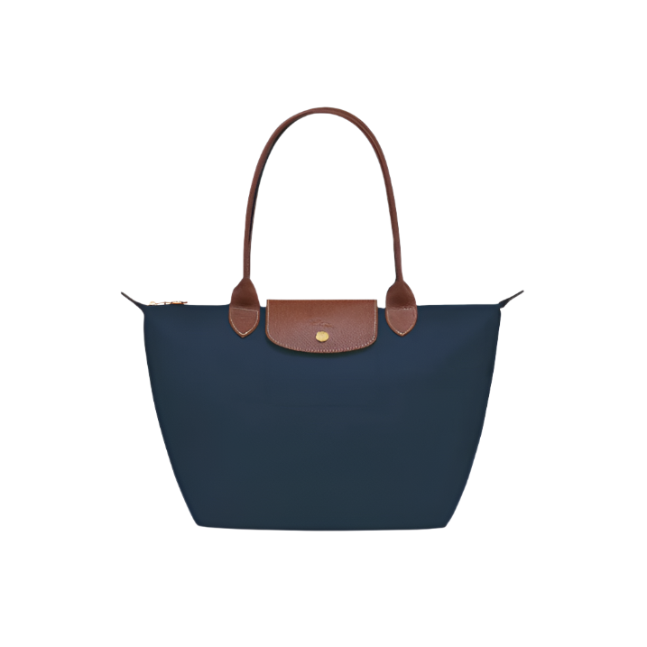 Tote handbag with brown leather handle and trim on a light gray background- Navy blue purse