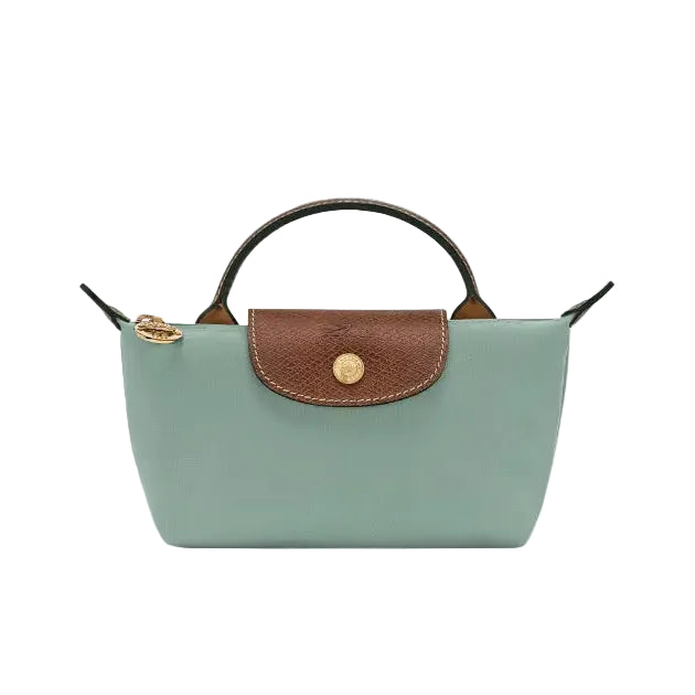 A mint green leather handbag with a brown textured flap, gold-tone hardware, and a top handle, shown against a plain light gray background.