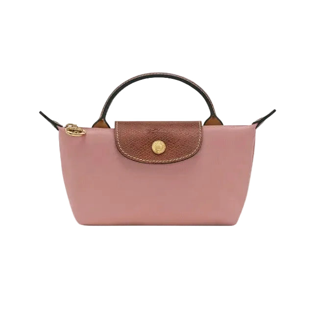 A pink leather handbag with a brown flap, gold-tone hardware, and a top handle, shown against a light gray background.