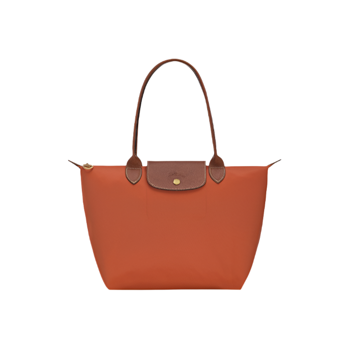 Orange handbag with brown leather accents on a light gray background-orange purse